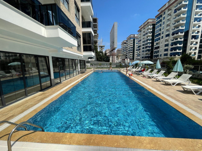 1+1 apartment for sale with mountain view in the center of the popular area of Alanya - Mahmutlar