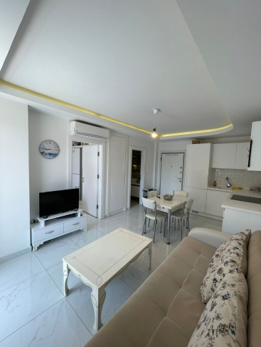 Fully furnished 1+1 in Alanya center — residence permit eligible, 600 m from the sea