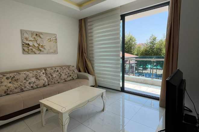 Fully furnished 1+1 in Alanya center — residence permit eligible, 600 m from the sea
