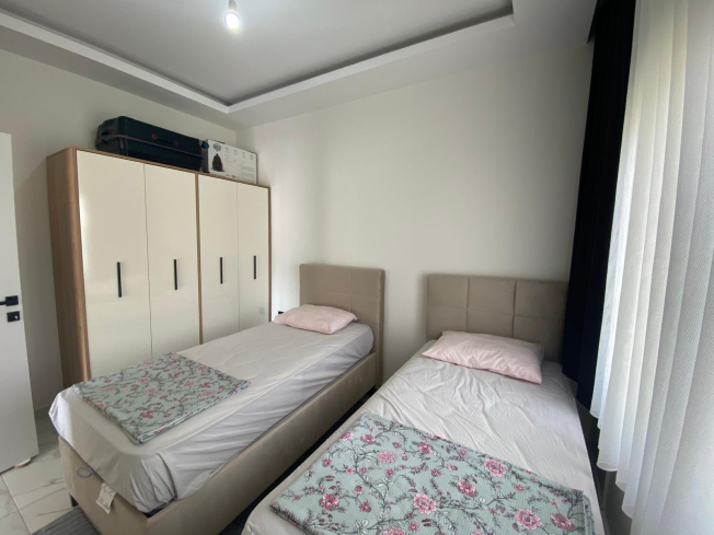 Modern 2+1 Apartment with Private Garden and Direct Pool Access in Demirtaş