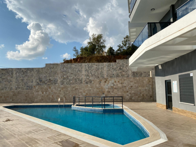 Modern 2+1 Apartment with Private Garden and Direct Pool Access in Demirtaş