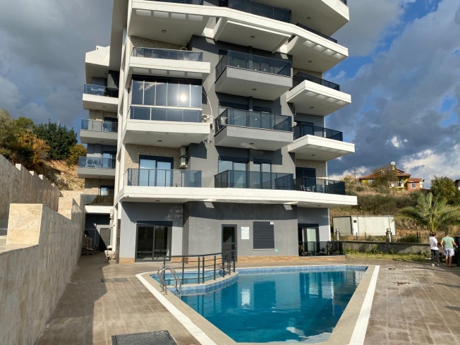 Modern 2+1 Apartment with Private Garden and Direct Pool Access in Demirtaş