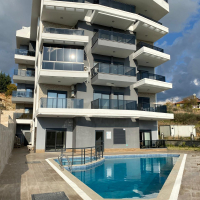 Modern 2+1 Apartment with Private Garden and Direct Pool Access in Demirtaş